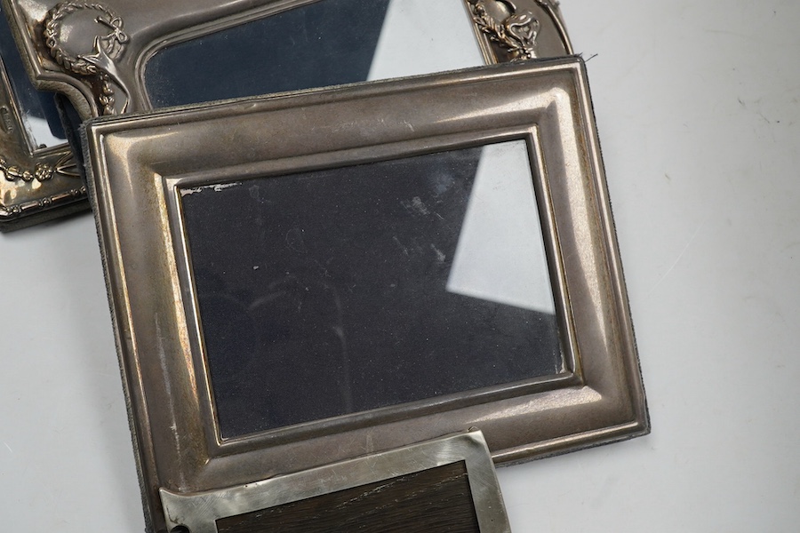 A small George V silver mounted photograph frame, 11.2cm, together with three larger modern silver mounted photograph fames and an 800 standard frame. Condition - poor to fair